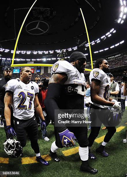 Ray Rice, Ray Lewis and Torrey Smith of the Baltimore Ravens walk onto the field against the San Francisco 49ers during Super Bowl XLVII at the...