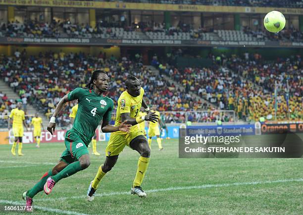 Togo's defender Vincent Bossou vies with Burkina Faso's defender Bakary Kone during the African Cup of Nation 2013 quarter final football match...