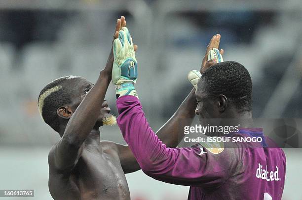 Burkina Faso's defender Mohamed Koffi and Burkina Faso's goalkeeper Daouda Diakite celebrate at the end of the African Cup of Nation 2013 quarter...