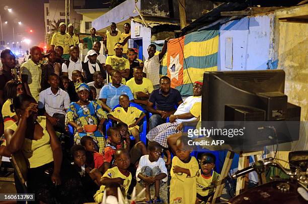 People watch on TV the African Cup of Nation 2013 quarter final football match between Burkina Faso and Togo, in Lome, on February 3, 2013. Burkina...