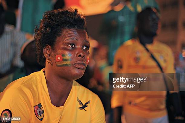 Woman bearing a flag of Togo on her cheek, watches the African Cup of Nation 2013 quarter final football match between Burkina Faso and Togo, in...