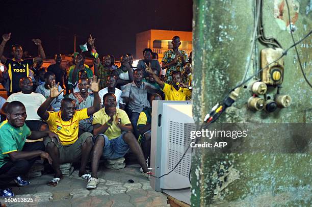 Supporters of the Togo football team watch on TV the African Cup of Nation 2013 quarter final football match between Burkina Faso and Togo, in Lome,...