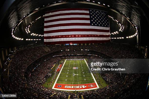 Kicker Justin Tucker of the Baltimore Ravens kicks the opening kick-off to the San Francisco 49ers during Super Bowl XLVII at the Mercedes-Benz...