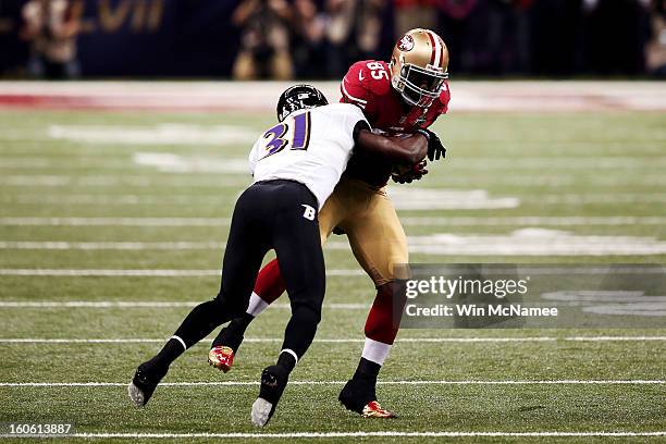 Vernon Davis of the San Francisco 49ers makes a reception in the first quarter against Bernard Pollard of the Baltimore Ravens during Super Bowl...