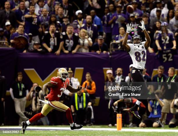 Torrey Smith of the Baltimore Ravens makes a catch in the first quarter against Donte Whitner of the San Francisco 49ers during Super Bowl XLVII at...