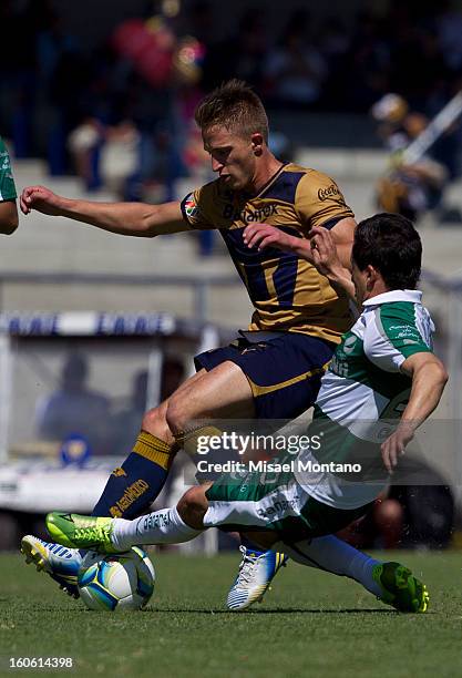 Jose Garcia of Pumas fights for the ball with Osmar Mares of Santos during a match between Pumas and Santos as part of the Clausura 2013 at Olímpico...