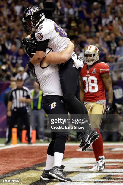 Dennis Pitta of the Baltimore Ravens celebrates with teammate Matt Birk after catching a touchdown pass in the second quarter against the San...