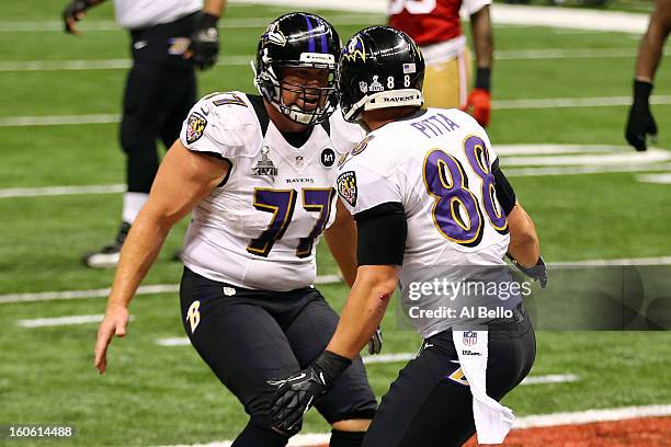 Dennis Pitta of the Baltimore Ravens celebrates with teammate Matt Birk after catching a touchdown pass in the second quarter against the San...