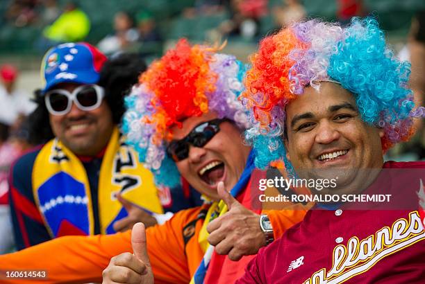 Fans of Magallanes of Venezuela cheer their team before a match against Criollos de Cagua of Puerto Rico, during the 2013 Caribbean baseball series,...