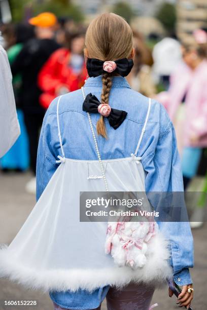 Guest wears pigtail outside Stine Goya during the Copenhagen Fashion Week Spring/Summer 2024 on August 09, 2023 in Copenhagen, Denmark.