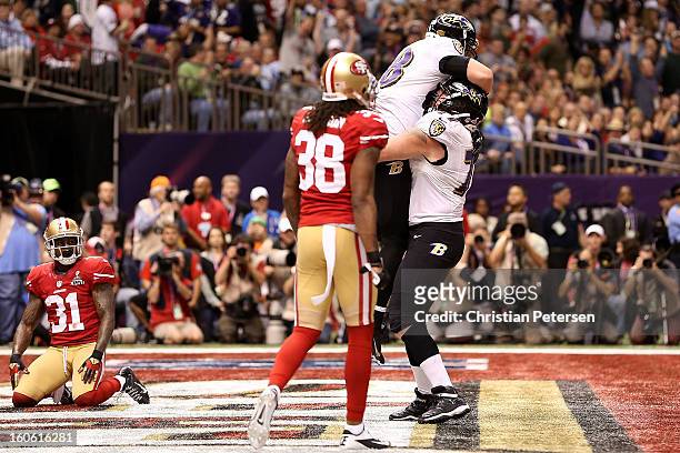 Dennis Pitta and Matt Birk of the Baltimore Ravens celebrate after Pitta caught a 1-yard touchdown pass in the second quarter against the San...