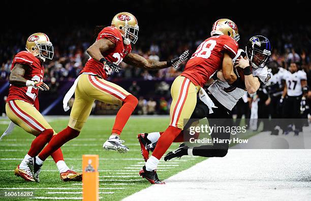 Kicker Justin Tucker of the Baltimore Ravens is stopped short of a first down on a fake field goal attempt in the second quarter by Darcel McBath of...