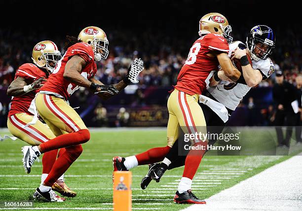 Kicker Justin Tucker of the Baltimore Ravens is stopped short of a first down on a fake field goal attempt in the second quarter by Darcel McBath of...