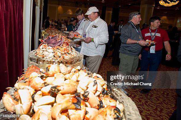 Attendees serve themselves from an assortment of seafood items during the Ultimate Super Bowl Tailgate Party hosted by Michael Strahan at Harrah's...