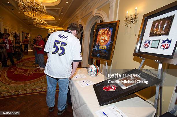 Attendees browse items up for auction during the Ultimate Super Bowl Tailgate Party hosted by Michael Strahan at Harrah's Casino on February 3, 2013...