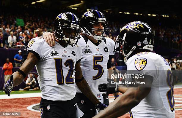Jacoby Jones, Joe Flacco and Anquan Boldin of the Baltimore Ravens celebrate after Jones caught a 56-yard touchdown pass from Flacco in the second...