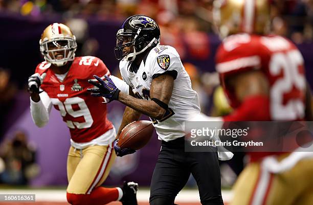 Jacoby Jones of the Baltimore Ravens runs with the ball for a 56 yard touchdown past Chris Culliver of the San Francisco 49ers in the second quarter...