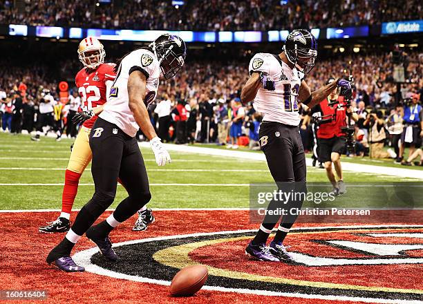 Jacoby Jones and Torrey Smith of the Baltimore Ravens celebrate after Jones scored on a 56-yard touchdown reception in the second quarter against...