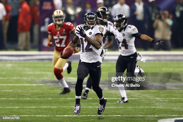 Jacoby Jones of the Baltimore Ravens runs back a record 108-yard kickoff return for a touchdown in the third quarter against the San Francisco 49ers...