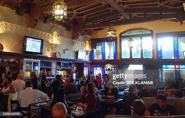 People watch Super Bowl XLVII , the San Francisco 49ers vs The Baltimore Ravens, on televisions in Hollywood's oldest restaurant and pub Pig'n...