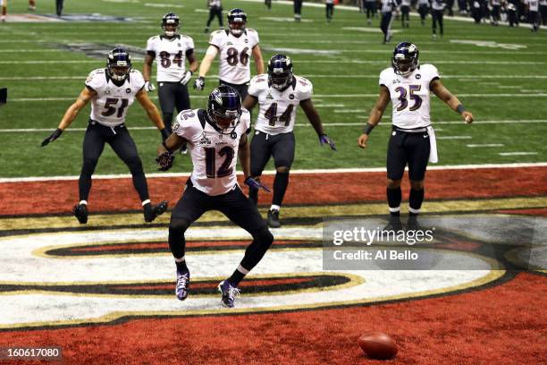 Jacoby Jones of the Baltimore Ravens celebrates his record 108-yard kickoff return for a touchdown with his teammates in the third quarter against...