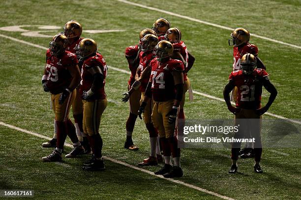 The San Francisco 49ers stand on the field after a sudden power outage in the second half during Super Bowl XLVII at the Mercedes-Benz Superdome on...