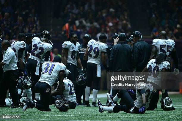 The Baltimore Ravens sit on the field after a sudden power outage in the second half during Super Bowl XLVII at the Mercedes-Benz Superdome on...