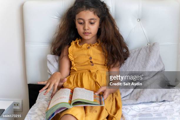 the girl reading a book. - kurdish girl stock pictures, royalty-free photos & images