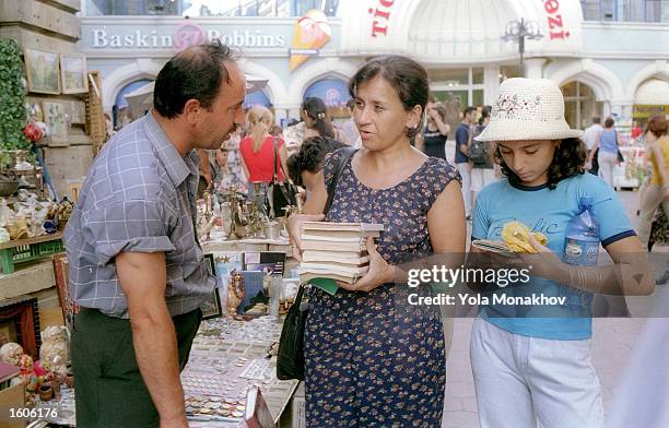 Mother and daughter buy used Cyrillic Azeri language books August 2, 2001 in downtown Baku, Azerbaijan. In accordance with a decree issued by...