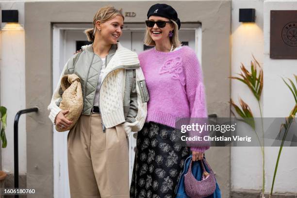 Hollie Mercedes Peters wears bomber jacket, beige pants, Bottega Veneta bag & Sonja Leigh wears pink knit, beret, skirt with print outside Baum &...