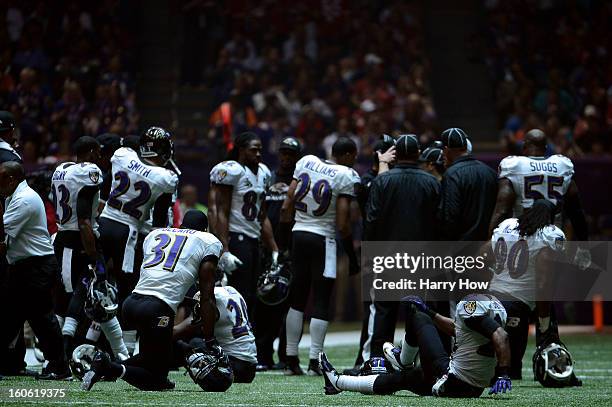 The Baltimore Ravens sit on the field after a sudden power outage in the second half during Super Bowl XLVII at the Mercedes-Benz Superdome on...