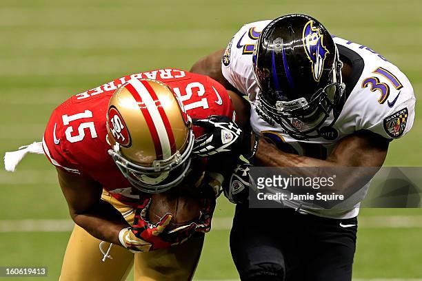 Michael Crabtree of the San Francisco 49ers breaks a tackle against Bernard Pollard of the Baltimore Ravens and runs in for a touchdown in the third...