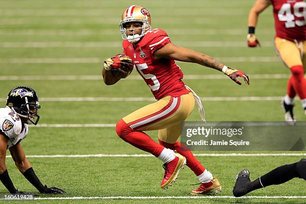Michael Crabtree of the San Francisco 49ers runs with the ball before scoring a touchdown in front of Cary Williams of the Baltimore Ravens in the...
