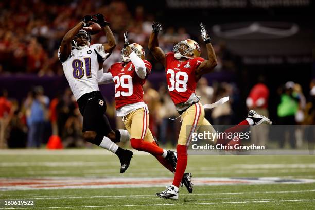 Anquan Boldin of the Baltimore Ravens attempts to catch a pass in front of Chris Culliver and Dashon Goldson of the San Francisco 49ers in the second...