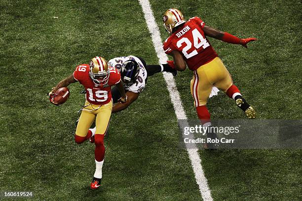 Ted Ginn of the San Francisco 49ers returns a punt 32 yards in the third quarter against Albert McClellan of the Baltimore Ravens during Super Bowl...