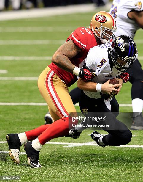 Joe Flacco of the Baltimore Ravens is sacked by Ahmad Brooks of the San Francisco 49ers in the second half during Super Bowl XLVII at the...