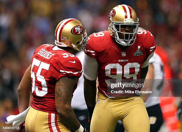 Aldon Smith of the San Francisco 49ers celebrates a sack with teammate Ahmad Brooks against the Baltimore Ravens during Super Bowl XLVII at the...