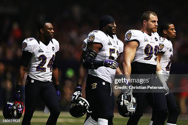 Corey Graham, Ray Lewis and Paul Kruger of the Baltimore Ravens walk towards the sideline as play was suspended in the third quarter for 34 minutes...