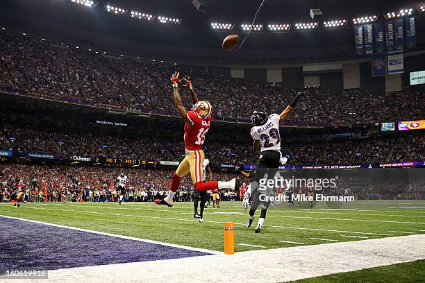 Cary Williams of the Baltimore Ravens breaks up a pass in front of Ted Ginn of the San Francisco 49ers in the third quarter during Super Bowl XLVII...