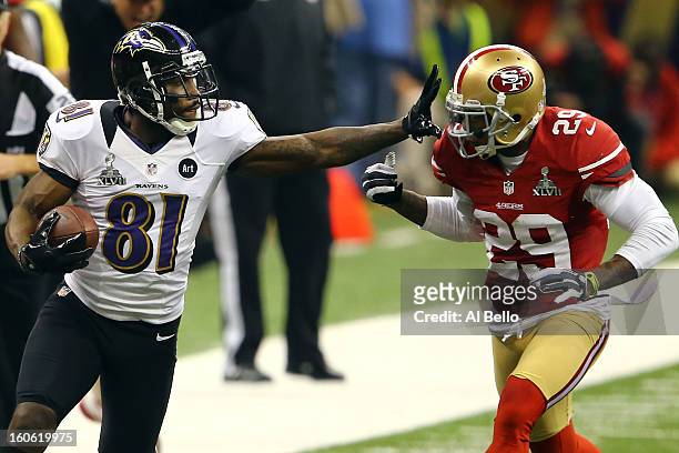 Anquan Boldin of the Baltimore Ravens runs with the ball past Chris Culliver of the San Francisco 49ers after catching a pass in the second half...