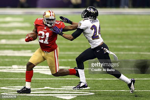 Frank Gore of the San Francisco 49ers breaks a tackle against Corey Graham of the Baltimore Ravens as he runs for a touchdown in the second half...