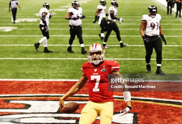 Colin Kaepernick of the San Francisco 49ers celebrates after he scored a 15-yard rushing touchdown in the fourth quarter against the Baltimore Ravens...