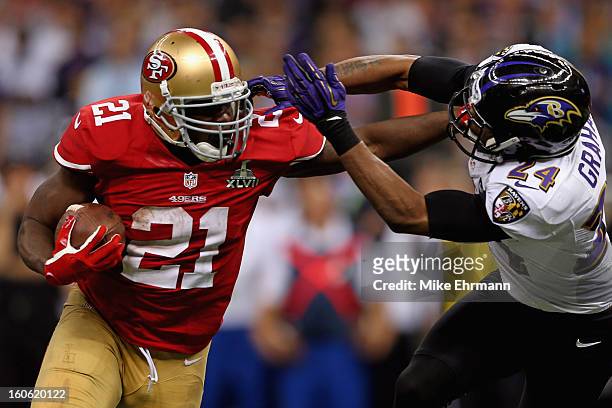 Frank Gore of the San Francisco 49ers breaks a tackle against Corey Graham of the Baltimore Ravens as he runs for a touchdown in the second half...