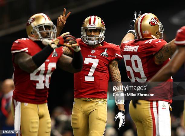 Colin Kaepernick of the San Francisco 49ers gestures to go for a two-point conversion after scoring a rushing touchdown in the second half against...
