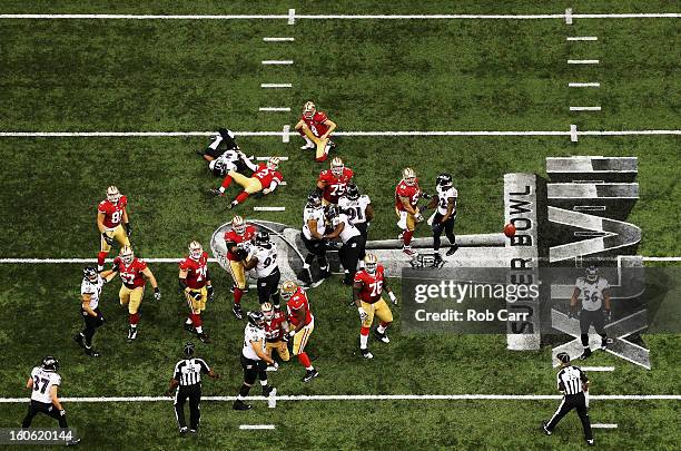 David Akers of the San Francisco 49ers gets roughed by Chykie Brown of the Baltimore Ravens while attempting a field goal in the third quarter...