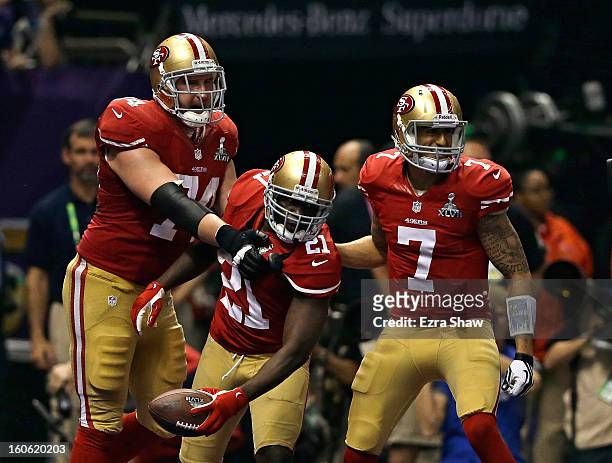 Frank Gore of the San Francisco 49ers celebrates with teammates Colin Kaepernick and Joe Staley after scoring a touchdown in the third quarter...