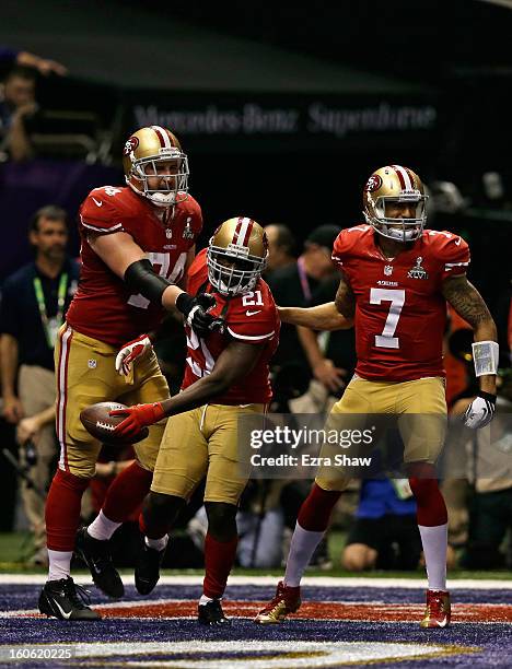 Frank Gore of the San Francisco 49ers celebrates with teammates Colin Kaepernick and Joe Staley after scoring a touchdown in the third quarter...