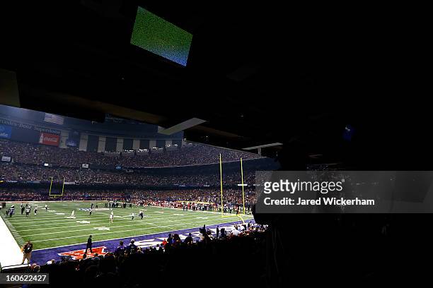 Fans look on to the field after a sudden power outage in the second quarter during Super Bowl XLVII at the Mercedes-Benz Superdome on February 3,...