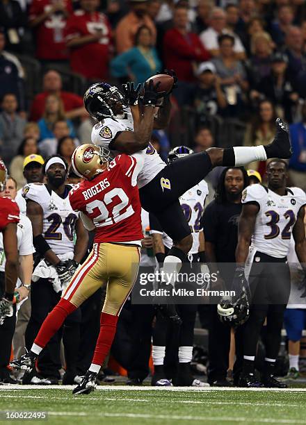 Anquan Boldin of the Baltimore Ravens catches a third down pass over Carlos Rogers of the San Francisco 49ers at the 7:10 mark in the fourth quarter...