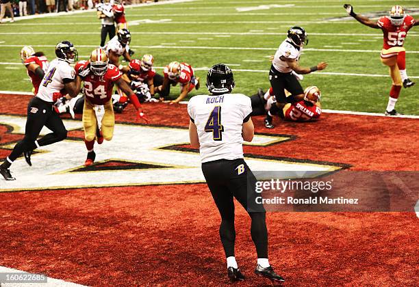 Punter Sam Koch of the Baltimore Ravens holds the ball in the endzone as he takes a safety in the final minute of the fourth quarter against the San...